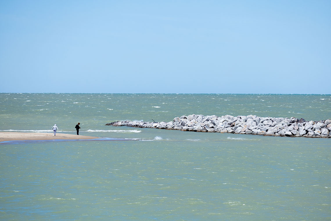 people fishing on beach