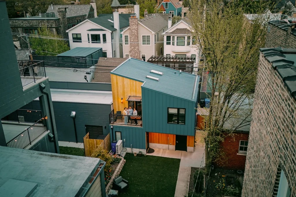 A bird's eye view of a family standing on the balcony of their home